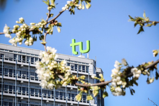 TU Dortmund University Spring_02 The TU building surrounded by blooming cherry blossoms.