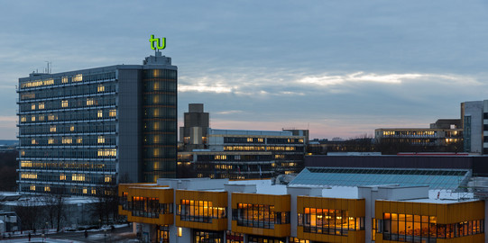 Maths Tower and dining hall at dusk in winter.